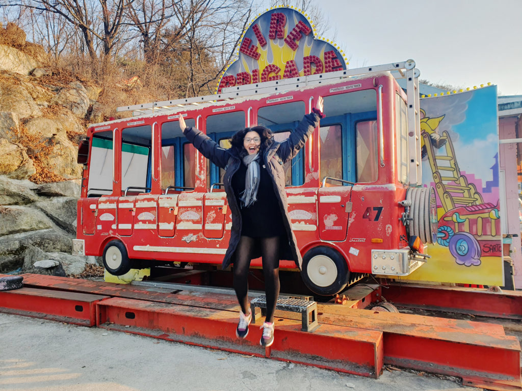 Woman jumping for photo in touristic place